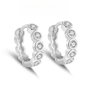 Macro detail of S925 silver hoop earrings featuring micro-pave round cubic zirconia stones