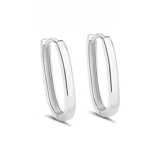 Close-up detail of S925 sterling silver stamp on minimalist silver U-shaped hoop earrings