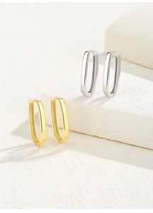 Detailed view of polished S925 silver U-shaped hoop earrings in gold and silver finishes