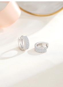 Macro shot of S925 sterling silver hoop earrings featuring three rows of micro-pave zircons