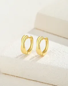 Close-up of gold-plated S925 sterling silver hoop earrings with twisted texture design