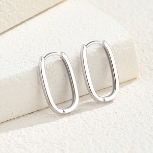 Elegant S925 sterling silver U-shaped oval hoop earrings on white marble stone