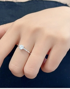 Close-up of S925 silver ring with a round diamond and braided rope texture band
