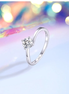 Macro shot of S925 silver bypass ring showing four-claw setting with round brilliant stone