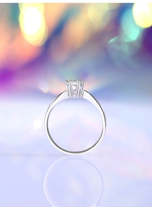 Macro shot of silver six-prong moissanite ring with luxury round cut diamond detail
