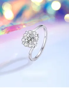 Macro view of S925 silver ring with flower-shaped moissanite stones and open band detail