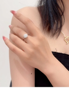 Detail of S925 silver ring featuring a clustered zircon flower design on a model finger