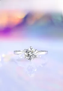 Macro shot of 1ct round brilliant cut moissanite set in 6-prong silver engagement ring