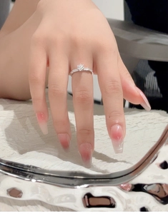 Macro view of S925 silver 0.5ct moissanite ring with classic six-prong setting on finger