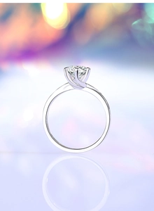 Detail of 1ct six-prong moissanite ring with twisted band and polished silver finish