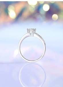 Detailed view of 0.5ct moissanite ring with classic six-prong setting and side diamonds