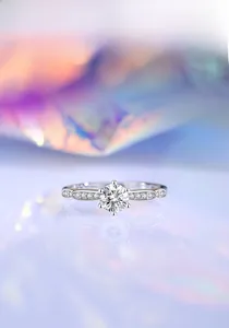 Close-up of a classic six-prong S925 silver ring with a 0.5ct moissanite and side stones