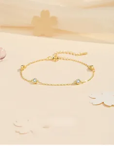 Detail of S925 sterling silver gold plated bracelet with bezel set cubic zirconia crystals