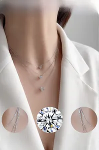 Close-up of triple-layered silver necklace with round cubic zirconia on a female model