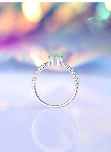 Macro shot of a 5mm moissanite ring with six-prong setting and beaded band detail