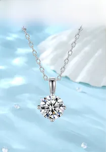 Macro view of a 1ct moissanite pendant with silver four-claw setting on blue background
