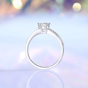 Elegant S925 silver 0.5ct moissanite ring with six-prong crown setting on blue bokeh background