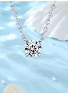 Macro detail of 1 carat round moissanite pendant with classic four-prong silver setting