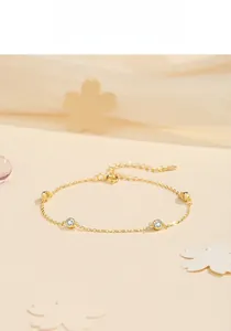 Detail of elegant gold S925 silver bracelet featuring round white zircon stones and lobster clasp