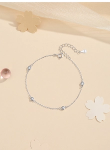 Macro detail of S925 sterling silver chain bracelet with four inlaid round zircons