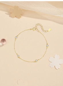 Detailed macro view of S925 sterling silver gold bracelet with four round clear stones