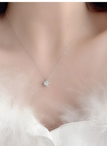 Macro close-up of a 1ct round moissanite pendant with a six-prong setting on S925 silver chain