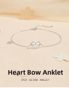 Detailed view of S925 silver bow anklet with a sparkling crystal heart charm