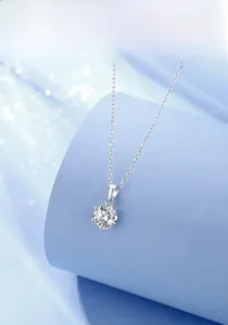 Detail of S925 sterling silver necklace with a brilliant round moissanite pendant