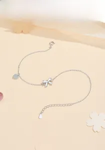Detail view of S925 sterling silver anklet with bow design and heart zircon charm