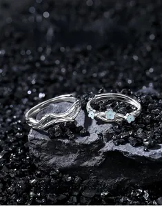 Detailed shot of S925 silver couple rings set with floral design on starry stones