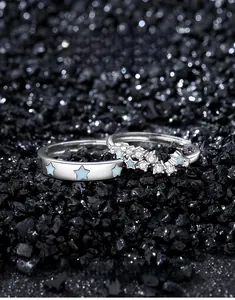 Macro view of S925 silver couple rings with blue star glaze and sparkling zircon accents