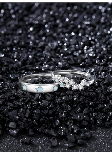 Macro detail of S925 sterling silver couple rings with star pattern and micro-inlaid stones