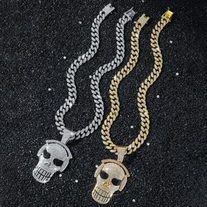 Hip hop skull with headphones pendant on iced out Cuban chains in gold and silver