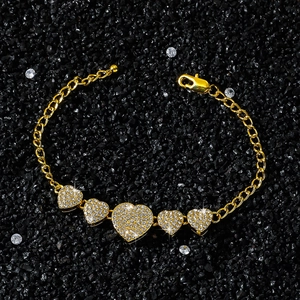 Hip hop style gold bracelet featuring five graduated heart pendants with zircon pave setting