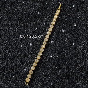 Detail of 8mm wide gold hip-hop bracelet with round diamonds on black textured background