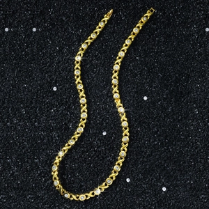 Gold 8mm XO chain link necklace with brilliant zircon stones on black background