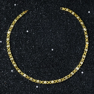 Macro detail of 8mm gold XO link chain with sparkling round cubic zirconia settings