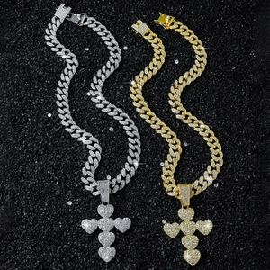 Iced-out Cuban chain necklace with heart cross pendant in gold and silver finishes