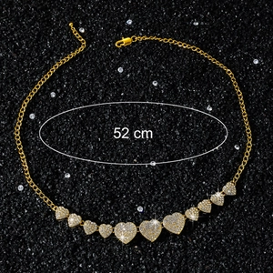 Detail of lobster clasp and extension chain on iced out gold heart necklace