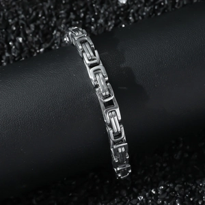 Mens 6mm silver stainless steel Byzantine chain bracelet on a black display stand