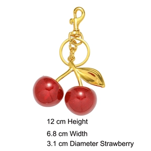 Detail view of resin cherry keychain with golden leaves and lobster clasp measurements