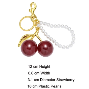 Detailed view of resin cherry keychain with pearls and gold leaf showing measurements