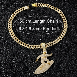 Detail showing 50cm gold Cuban chain and iced-out 6.8cm surfer boy pendant necklace