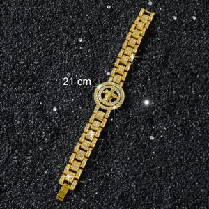 Close-up of hip-hop gold plated iced out bracelet with 21cm rotating cross charm