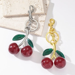 Cute cherry resin keychain with red glitter fruits and green leaves in gold and silver