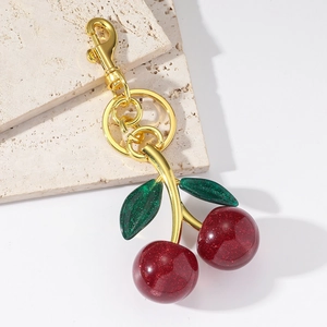 Sparkling red resin cherry keychain with green leaves and gold-plated lobster clasp