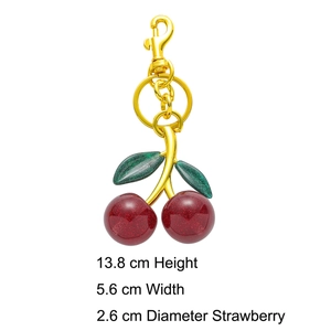 Detail view of resin cherry keychain with green glitter leaves and dimensions in cm