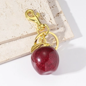 Porte-clés pomme en résine rouge foncé avec paillettes et quincaillerie dorée