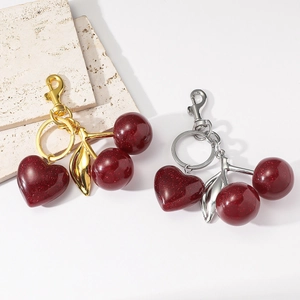 Sparkly red resin cherry and heart keychain pendant with gold and silver metal hardware