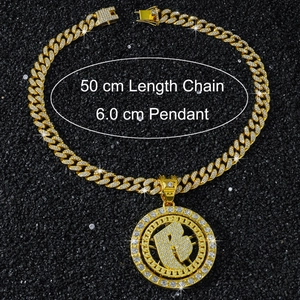 Macro view of 50cm gold Cuban chain with 6cm spinning iced-out letter B pendant